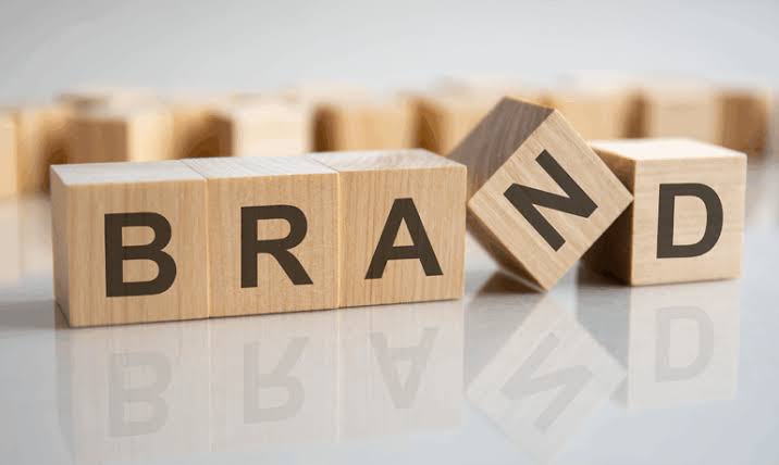 Wooden blocks spelling BRAND on a reflective surface